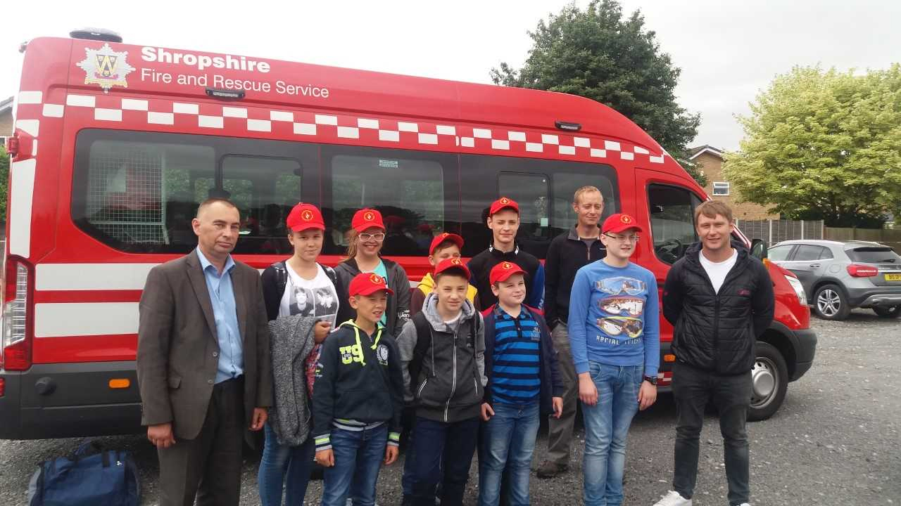 Firefighter Andy Davies (right) with the children from Chernobyl when they arrived at Manchester Airport without any luggage.