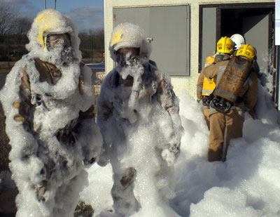 Firefighters covered in foam