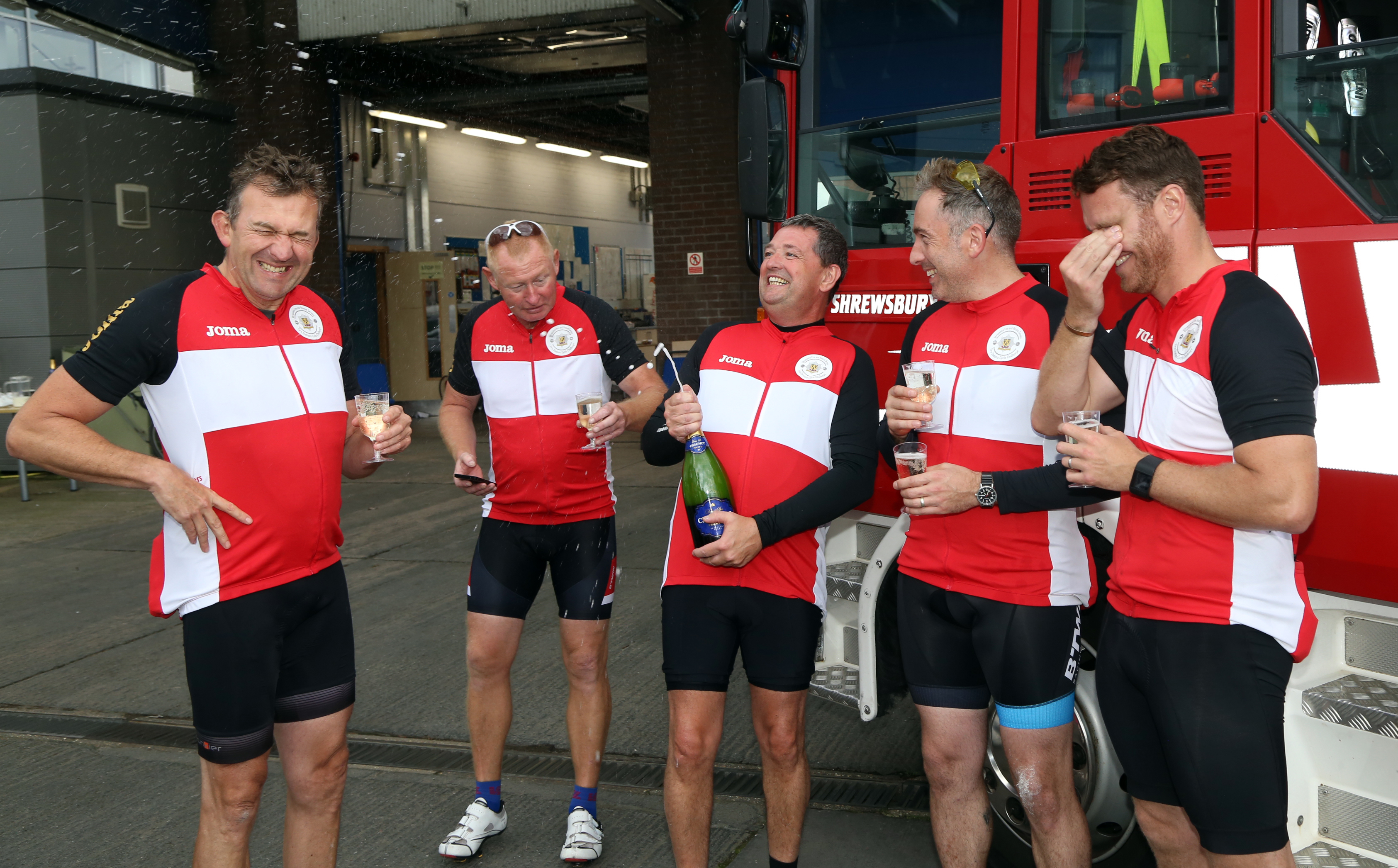 Champagne corks popped at the end of a marathon three day charity cycle ride in aid of The Severn Hospice and the Fire Fighters Charity by members of Shropshire Fire and Rescue Service.