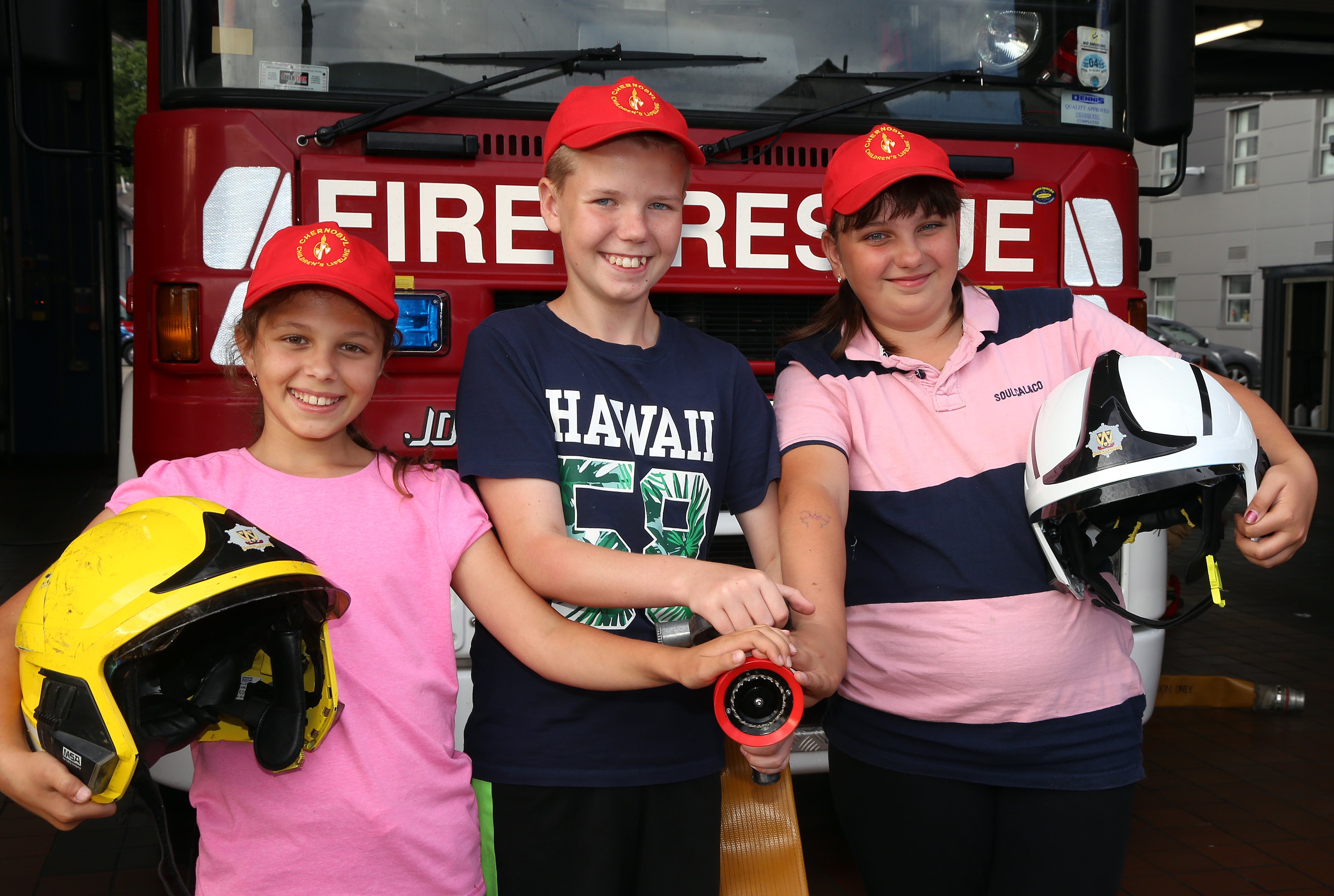 The children with the hose and helmets are L-R, Diana Kamesh (10), Andrey Demidenko (11) and Mariya Kuzmenko (12). 
