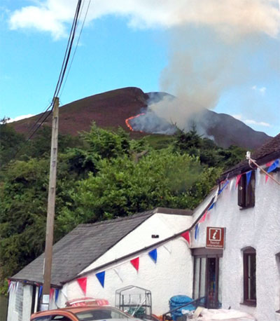 Fire and smoke on the Stiperstones with blue sky behind