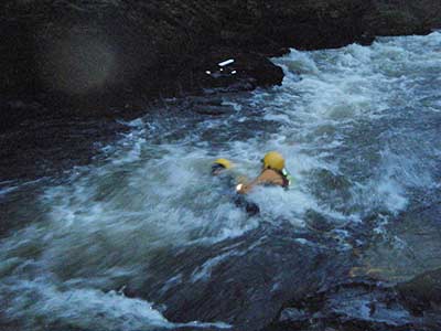 2 firefighters are hardly visible in wild looking river