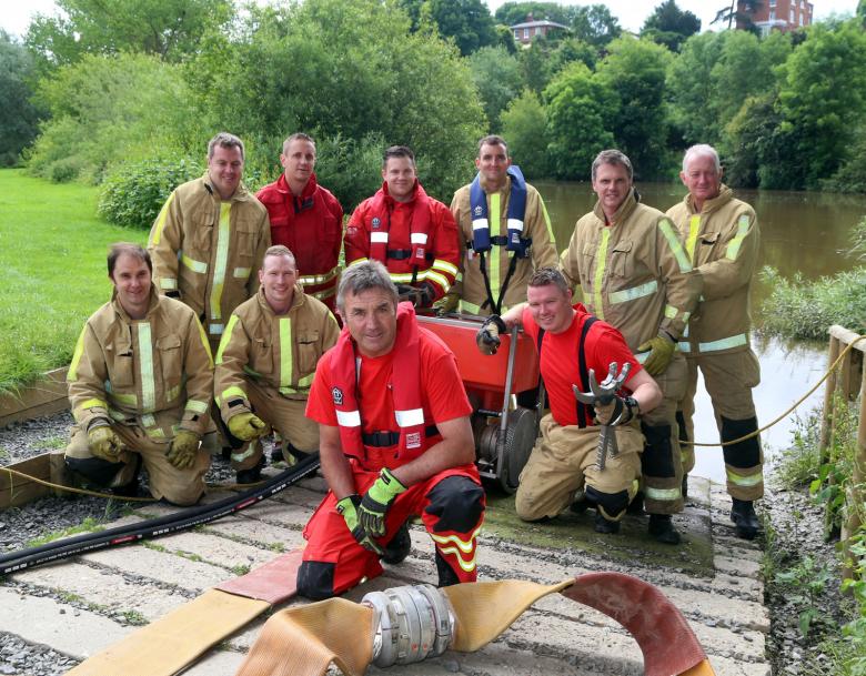 Tactical advisor Mac Harris with firefighters at the West Midlands showground by the River Severn in Shrewsbury, in training for the next floods disaster